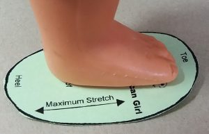 Checking sole size with doll foot
